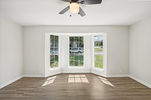 empty room with ceiling fan and dark hardwood / wood-style floors