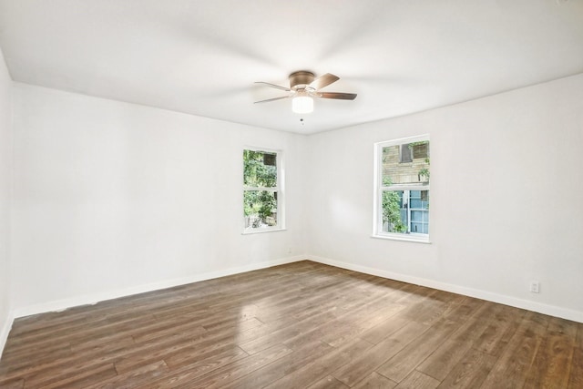 spare room with ceiling fan and dark wood-type flooring