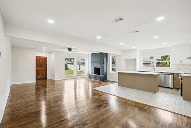 kitchen featuring stainless steel appliances, ceiling fan, white cabinets, light hardwood / wood-style floors, and a kitchen island