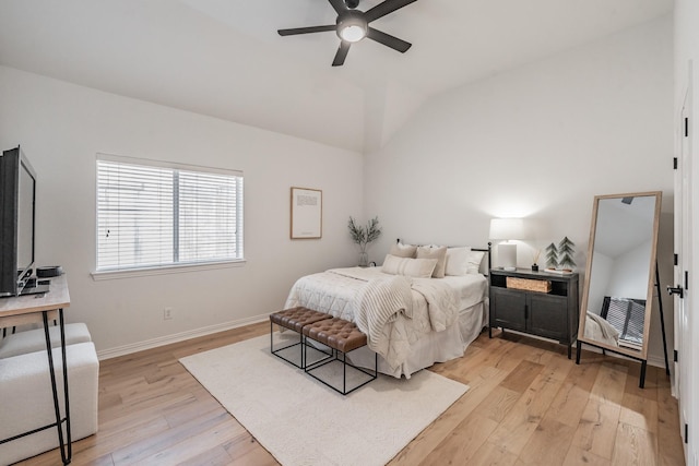 bedroom featuring ceiling fan, light hardwood / wood-style floors, and vaulted ceiling