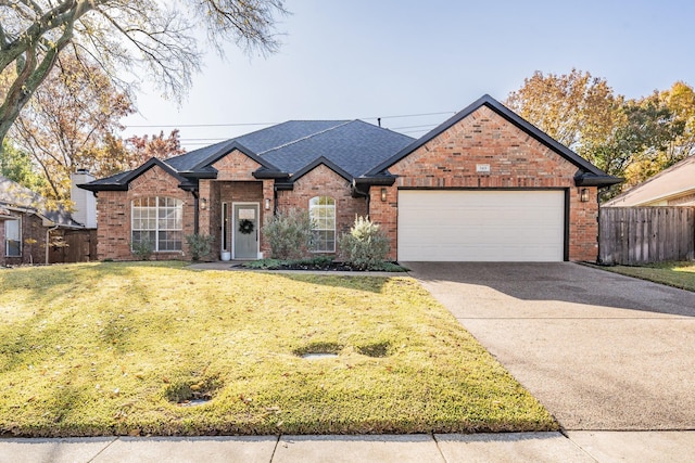 view of front of home with a front yard and a garage