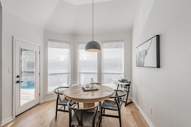 dining area with light wood-type flooring and a wealth of natural light