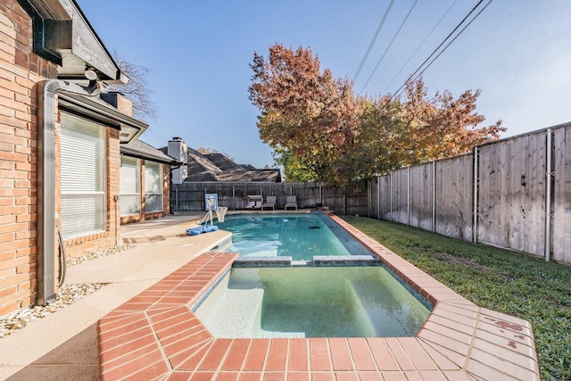 view of swimming pool with an in ground hot tub