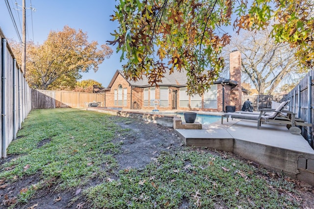 view of yard featuring a patio and a fenced in pool