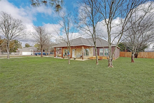 rear view of property with a patio and a lawn