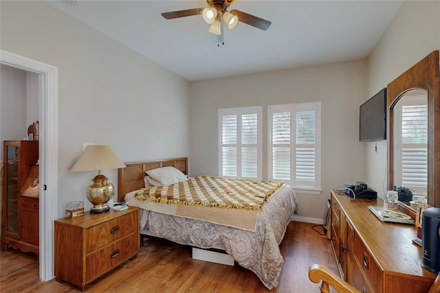 bedroom with dark wood-type flooring and ceiling fan