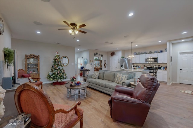 living room featuring ceiling fan and light wood-type flooring