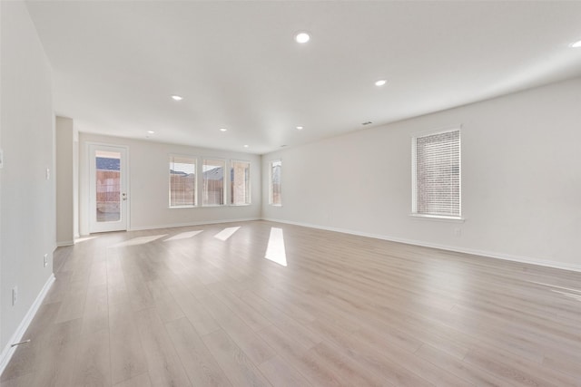 spare room with light hardwood / wood-style floors