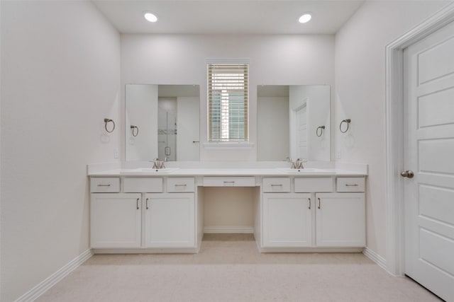 bathroom with vanity and a shower with door