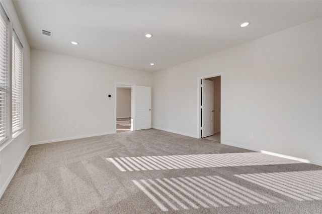 unfurnished bedroom featuring multiple windows and light carpet