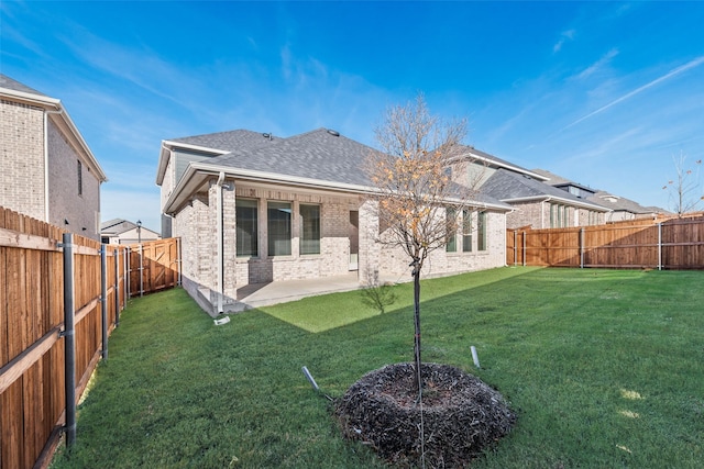 rear view of property featuring a yard and a patio