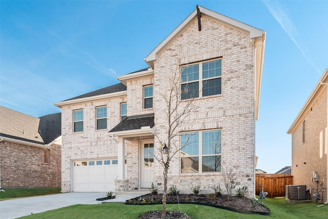 front facade featuring a garage, a front lawn, and central air condition unit