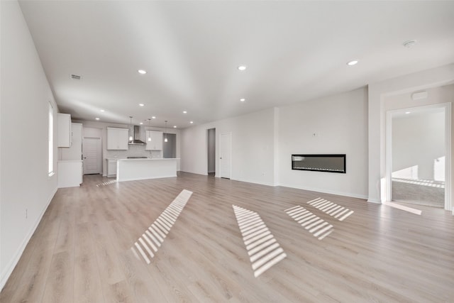 unfurnished living room with light hardwood / wood-style floors