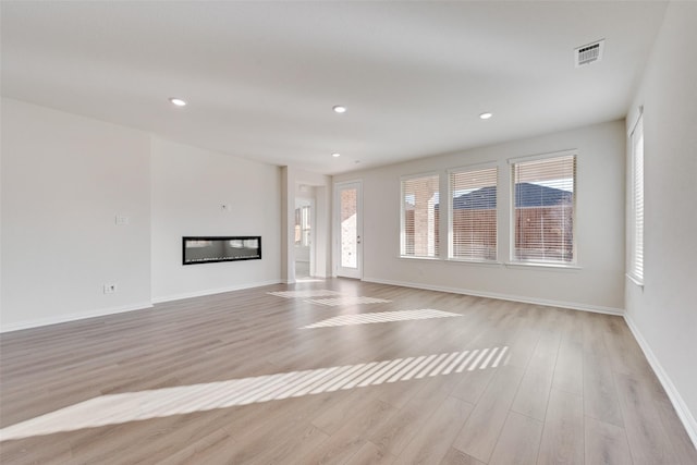 unfurnished living room featuring light wood-type flooring