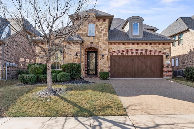 view of front of property with a front lawn and a garage