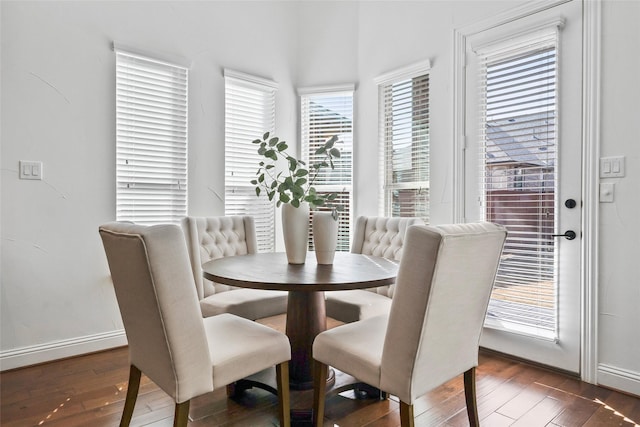 dining space with dark hardwood / wood-style flooring