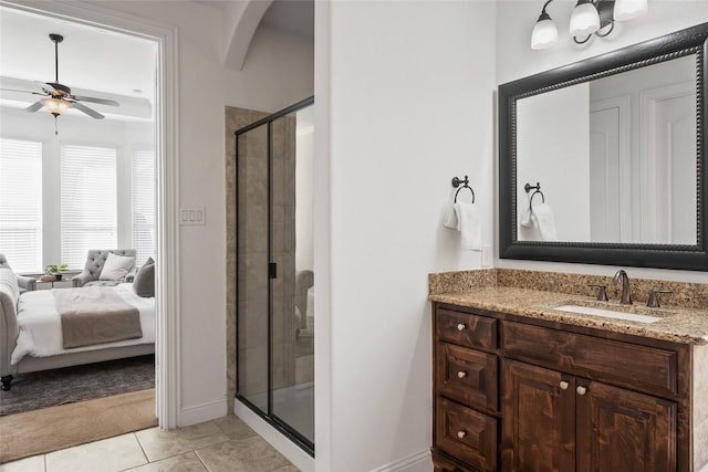 bathroom with tile patterned flooring, ceiling fan, a shower with shower door, and vanity