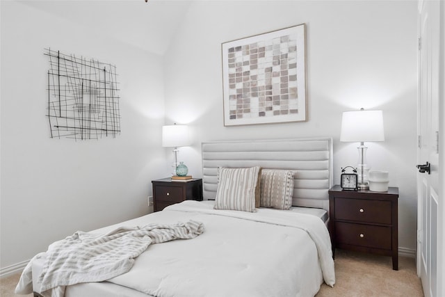 bedroom featuring vaulted ceiling and light carpet