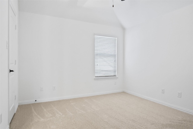 unfurnished room featuring vaulted ceiling and carpet flooring