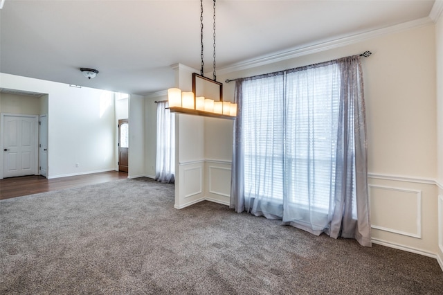 unfurnished dining area with carpet and ornamental molding