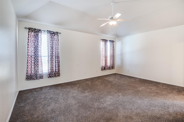 empty room with dark colored carpet, ceiling fan, and lofted ceiling