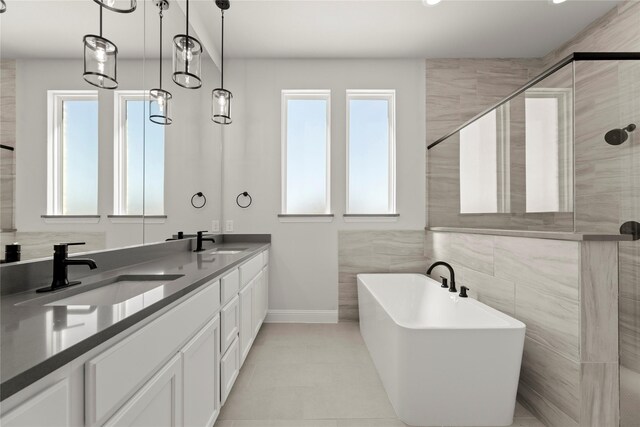 bathroom featuring tile patterned flooring, vanity, and independent shower and bath