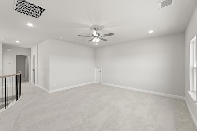 carpeted spare room with ceiling fan