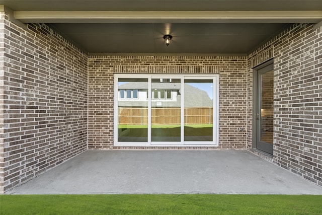 doorway to property with a patio area