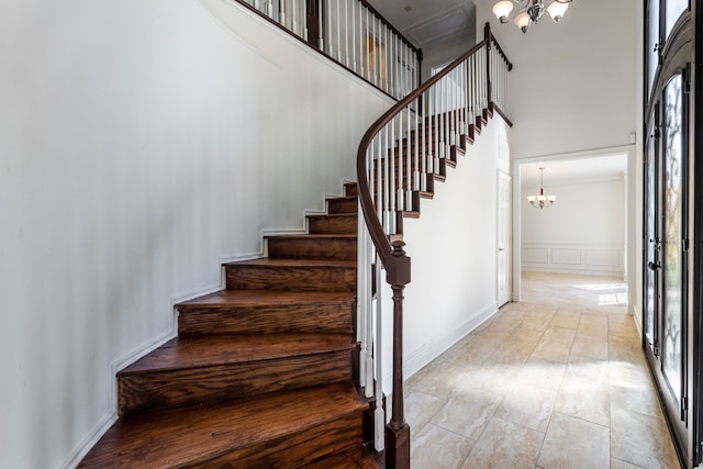 staircase featuring a notable chandelier and plenty of natural light