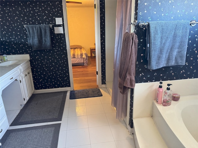 bathroom with vanity, tile patterned floors, and a tub