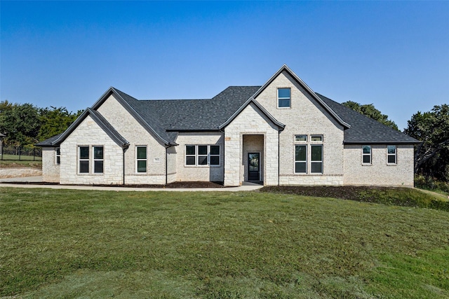 french provincial home featuring a front yard