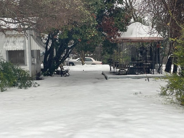 yard layered in snow featuring a playground