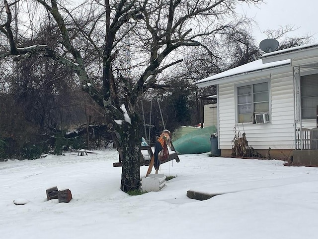 snowy yard featuring cooling unit