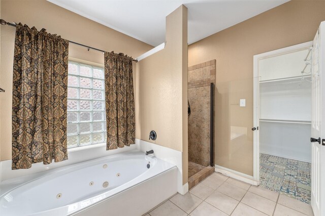 bathroom featuring tile patterned floors and separate shower and tub