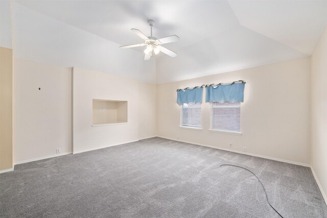 empty room with ceiling fan, lofted ceiling, and carpet