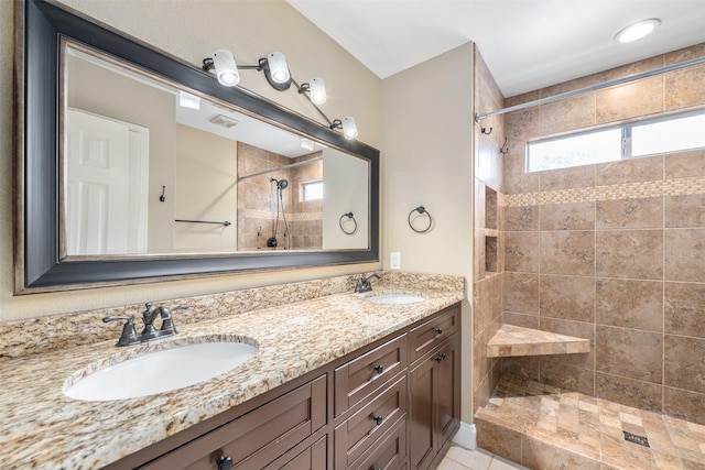 bathroom featuring vanity and a tile shower