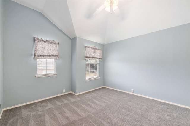 carpeted empty room with ceiling fan and vaulted ceiling