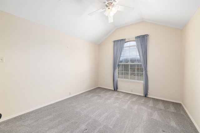 spare room featuring lofted ceiling, ceiling fan, and carpet flooring