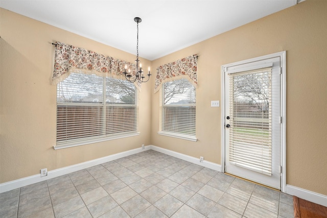 unfurnished dining area featuring a chandelier and tile patterned flooring