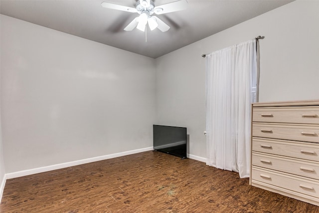 spare room featuring dark hardwood / wood-style flooring and ceiling fan