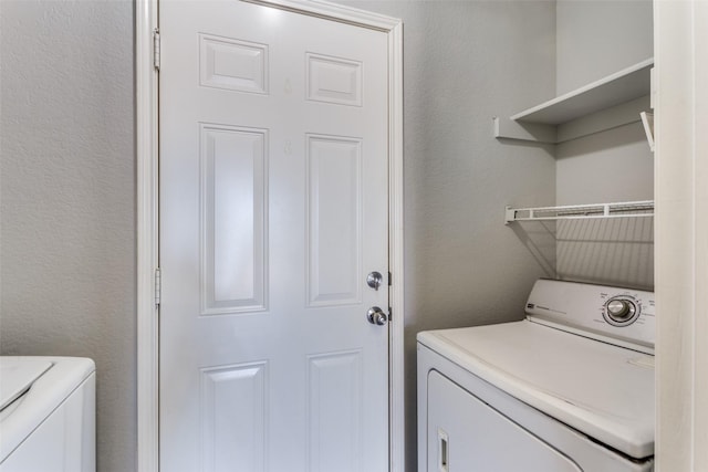 clothes washing area with separate washer and dryer