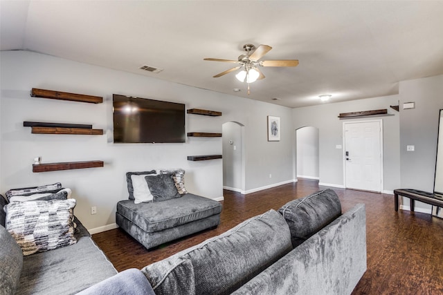 living room with ceiling fan and dark wood-type flooring