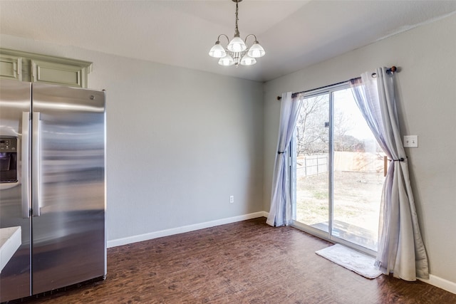 unfurnished dining area with dark hardwood / wood-style flooring and a notable chandelier