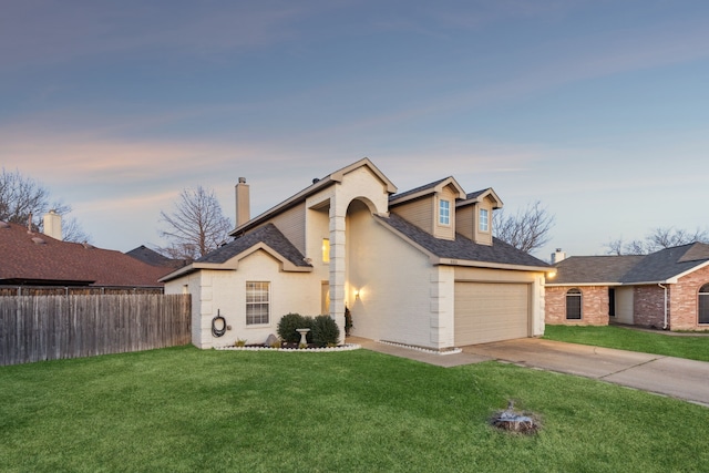 view of front of house with a garage and a yard