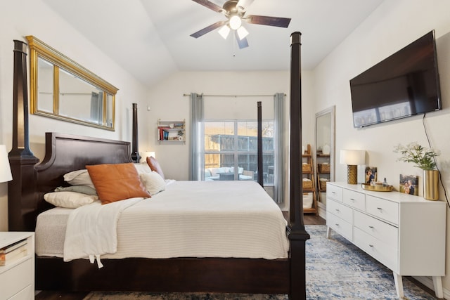 bedroom featuring dark hardwood / wood-style flooring, vaulted ceiling, and ceiling fan