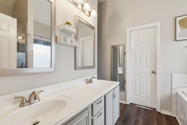 bathroom with hardwood / wood-style floors, vanity, and separate shower and tub