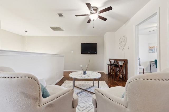 living room featuring ceiling fan and dark hardwood / wood-style floors