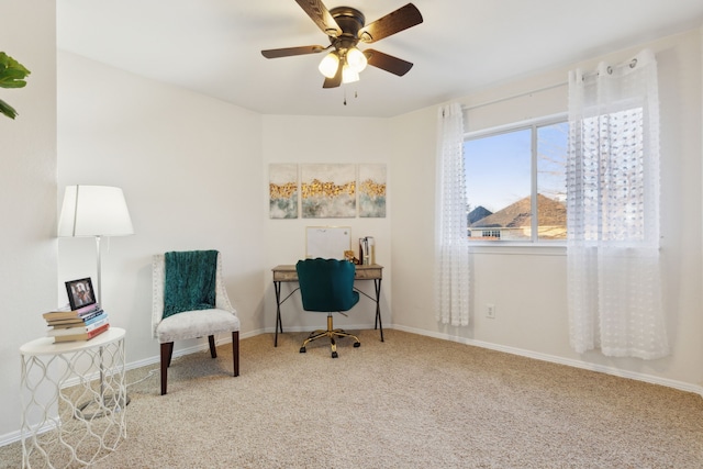 living area with ceiling fan and carpet