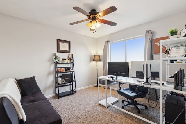 carpeted office space featuring ceiling fan