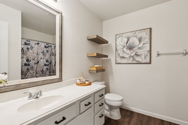 bathroom featuring hardwood / wood-style flooring, vanity, and toilet